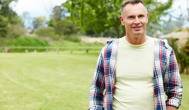 Smiling middle age man walking outside